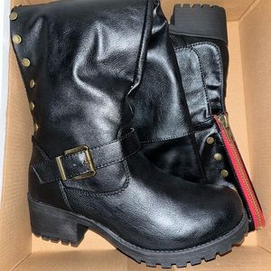 Knee high black combat boots .